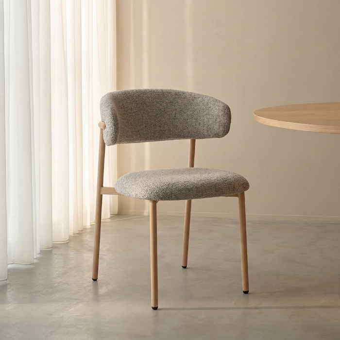 Stoffen eetkamerstoel Kevin in beige met naturel poten aan de eettafel