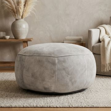 Leren ronde poef lichtgrijs. 